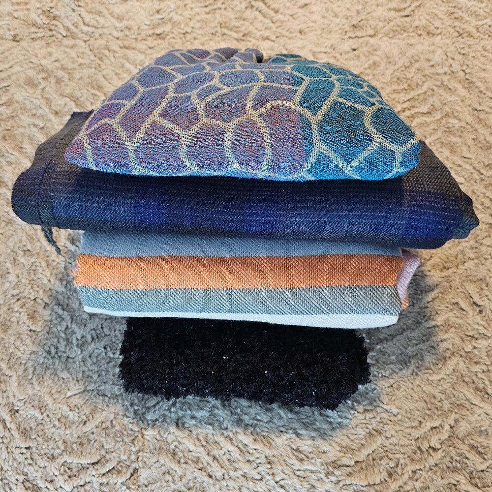 Four scarves with various textures and color patterns